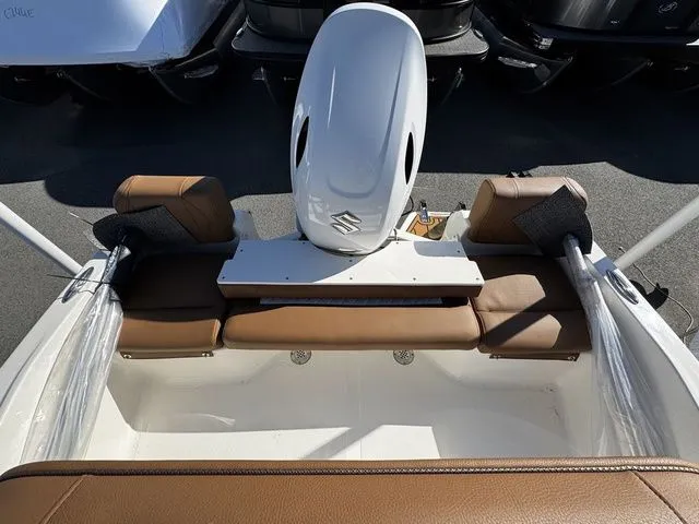 Slide: The Image of 2025 Pioneer Islander 180 boat interior with brown seating and outboard motor. - 10