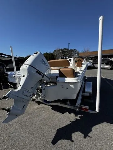 Slide: The Image of 2025 Pioneer Islander 180 boat with Suzuki outboard motor, parked on a trailer. - 3