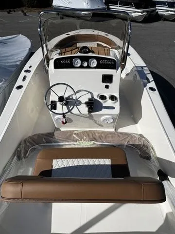 Slide: The Image of 2025 Pioneer Islander 180 boat interior with steering wheel and dashboard controls. - 4