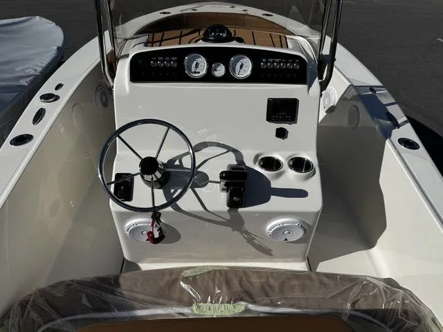 Slide: The Image of 2025 Pioneer Islander 180 boat dashboard with steering wheel and controls. - 5