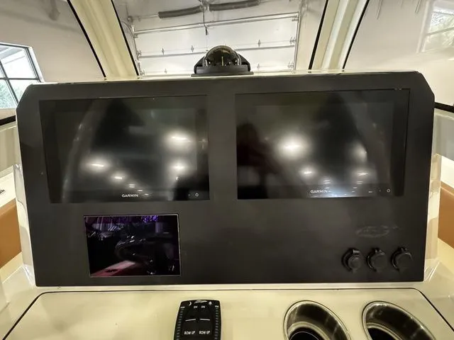 Slide: The Image of 2025 Pioneer Pelagic 270 dashboard with dual Garmin screens and controls. - 5