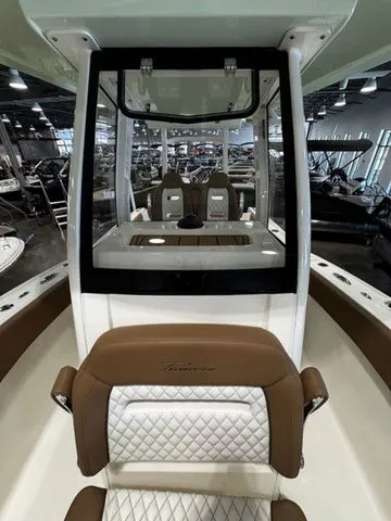 Slide: The Image of 2025 Pioneer Pelagic 270 boat interior with brown and white seating, showroom display. - 9