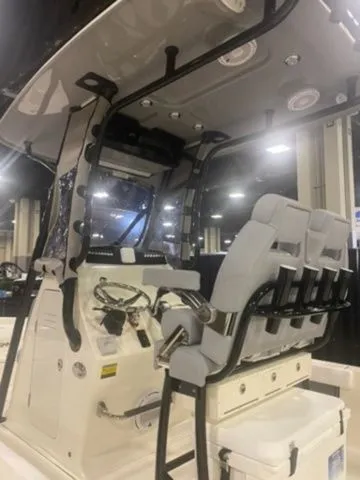 Slide: The Image of 2025 Avenger Boats AV24 interior with modern helm and seating at a boat show. - 3