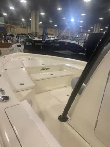 Slide: The Image of 2025 Avenger Boats AV24 on display at a boat show, showcasing sleek design and spacious deck. - 5