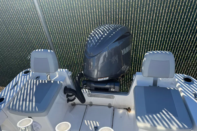 Slide: The Image of 2025 Bay Rider 219 Bay boat with Yamaha outboard motor, rear seating view. - 2