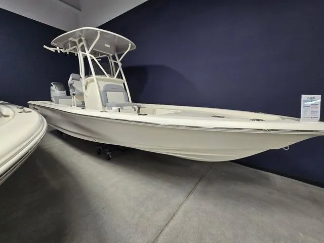 The Image of 2025 Avenger Boats AV26, sleek design, displayed indoors against a dark wall. - 1