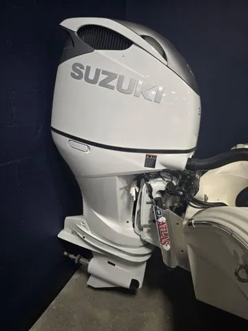 Slide: The Image of 2025 Avenger Boats AV26 with Suzuki outboard motor, showcased in a showroom setting. - 3