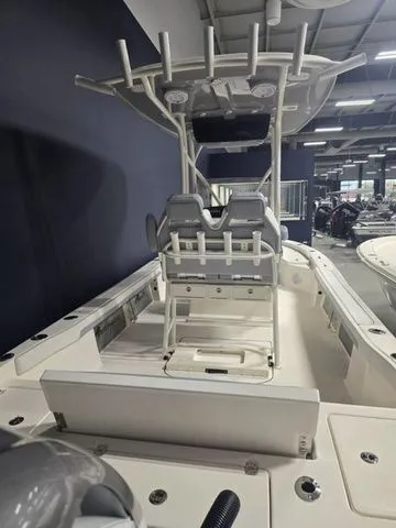 Slide: The Image of 2025 Avenger Boats AV26 interior with seating and T-top in showroom. - 4