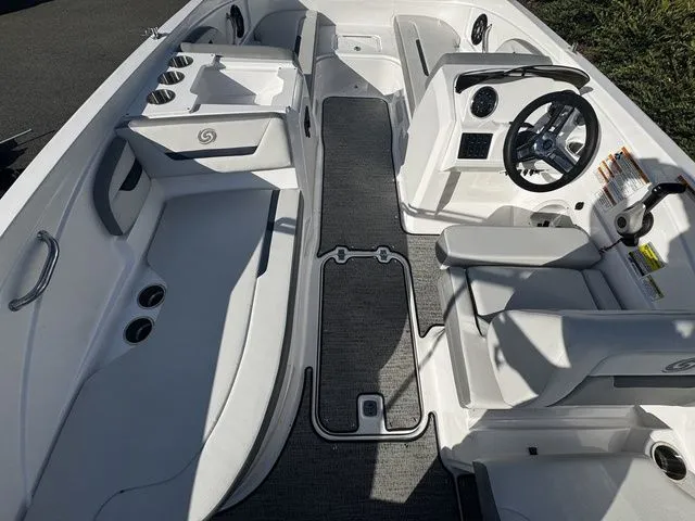 Slide: The Image of 2023 Hurricane SunDeck Sport 205 OB interior with seating, steering wheel, and cup holders. - 6