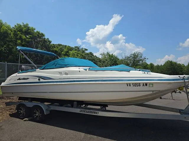 The Image of 2000 Hurricane SunDeck SD 237 OB boat on trailer, blue canopy, parked outdoors. - 1