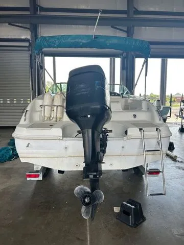 Slide: The Image of 2000 Hurricane SunDeck SD 237 OB boat in storage, rear view with outboard motor. - 2