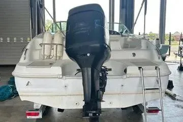 Slide: The Image of 2000 Hurricane SunDeck SD 237 OB boat with outboard motor in a storage facility. - 8