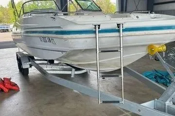 Slide: The Image of 2000 Hurricane SunDeck SD 237 OB boat on trailer in a garage. - 9