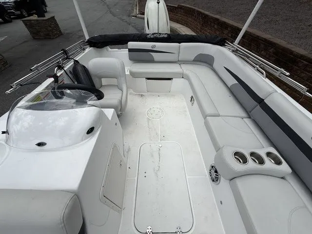 Slide: The Image of 2021 Hurricane SunDeck Sport 201 OB boat interior with spacious seating and steering console. - 11