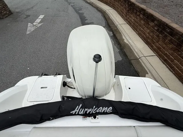 Slide: The Image of 2021 Hurricane SunDeck Sport 201 OB boat with outboard motor, parked on a paved surface. - 13