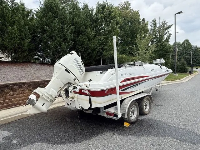 Slide: The Image of 2021 Hurricane SunDeck Sport 201 OB boat on trailer, parked on a street. - 3