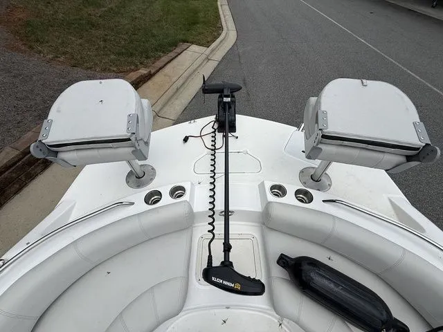 Slide: The Image of 2021 Hurricane SunDeck Sport 201 OB boat deck with seating and fishing rod holders. - 8