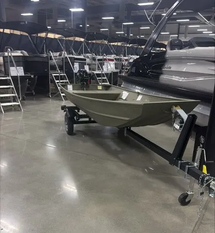 Slide: The Image of 2025 Crestliner 1436L CR Jon boat displayed indoors on a trailer. - 1