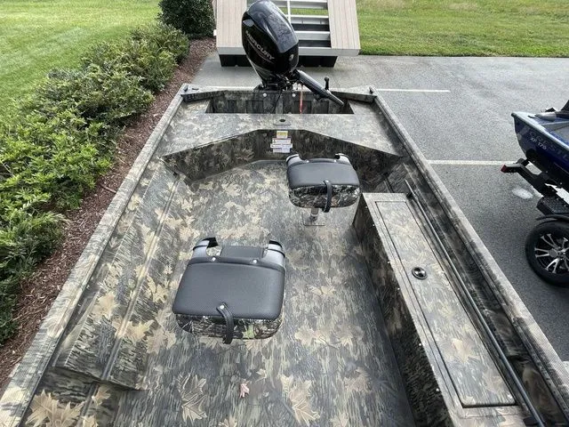 Slide: The Image of 2023 Crestliner 1760 Retriever Jon Deluxe boat with camo design and dual seats. - 7