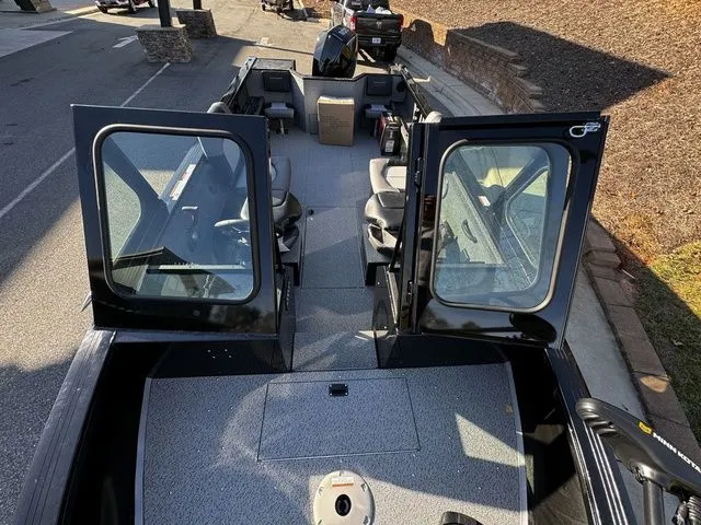 Slide: The Image of 2024 Crestliner 2050 Commander boat interior with open doors and seating arrangement. - 10