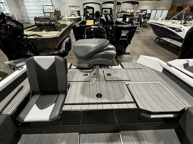 Slide: The Image of 2024 Vexus ADX190 boat interior with seating and storage compartments in a showroom. - 12
