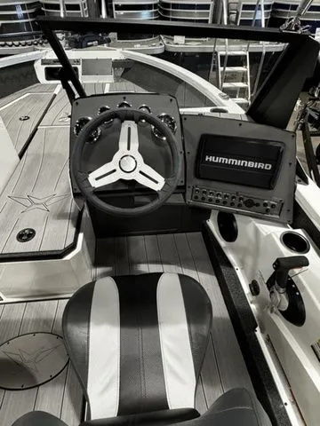 Slide: The Image of 2024 Vexus ADX190 boat cockpit with steering wheel and Humminbird navigation system. - 5