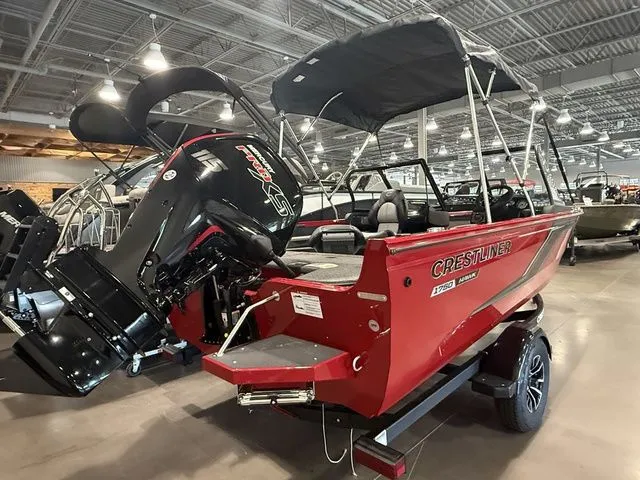 Slide: The Image of 2025 Crestliner 1750 Hawk boat in showroom, red exterior, powerful outboard motor, sleek design. - 3