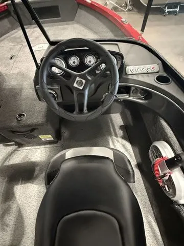 Slide: The Image of 2025 Crestliner 1750 Hawk boat interior with steering wheel and control panel. - 6