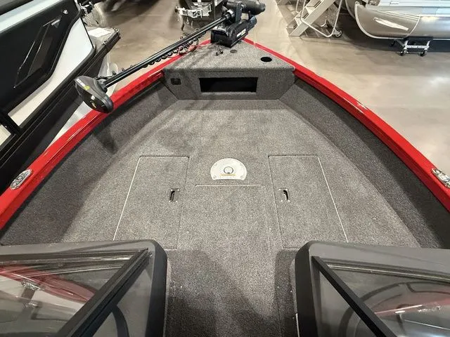 Slide: The Image of 2025 Crestliner 1750 Hawk boat interior with carpeted deck and trolling motor. - 8