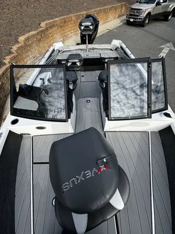 Slide: The Image of 2024 Vexus ADX190 boat with sleek design and modern features, parked on a road. - 12