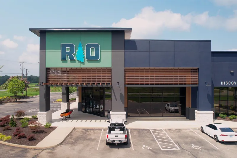Slide: The Image of Outdoor retail store with modern design, featuring large windows and a prominent "RIO" sign. - 11