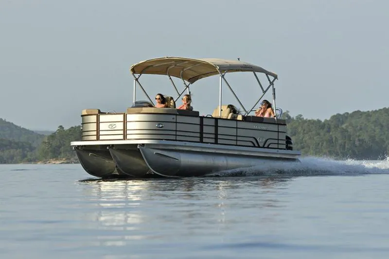 Slide: The Image of 2025 Veranda VR22VLC Tri-Toon cruising on a serene lake with passengers enjoying the ride. - 7
