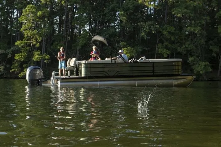 Slide: The Image of 2025 Veranda VR22VLC Tri-Toon boat on a lake with people fishing. - 8