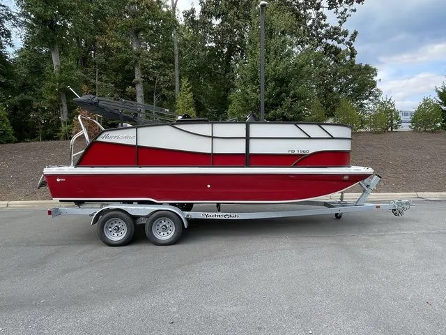 The Image of 2023 Hurricane FunDeck 1960 REF OB boat on trailer, parked outdoors. - 1