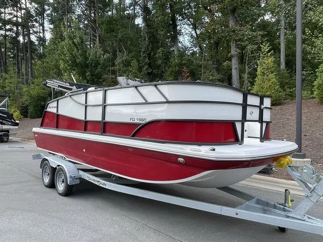 Slide: The Image of 2023 Hurricane FunDeck 1960 REF OB boat on trailer, parked in wooded area. - 2