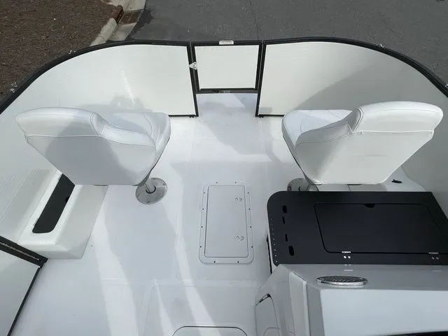 Slide: The Image of 2023 Hurricane FunDeck 1960 REF OB boat interior with white seating and storage compartments. - 6
