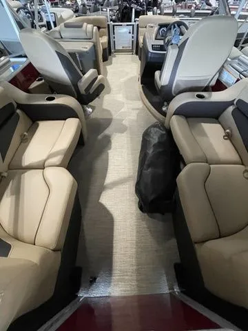 Slide: The Image of 2023 Barletta Boats C20QC interior with beige seating and modern dashboard. - 10