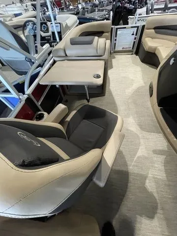 Slide: The Image of 2023 Barletta Boats C20QC interior with plush seating and table setup. - 12