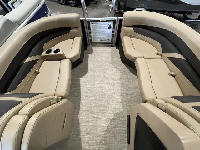 Slide: The Image of 2023 Barletta Boats C20QC interior with beige seating and cup holders. - 15