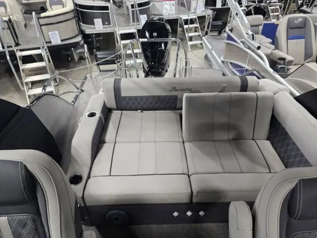 Slide: The Image of 2025 Barletta Boats R23UCA interior with luxurious seating and cup holders. - 5