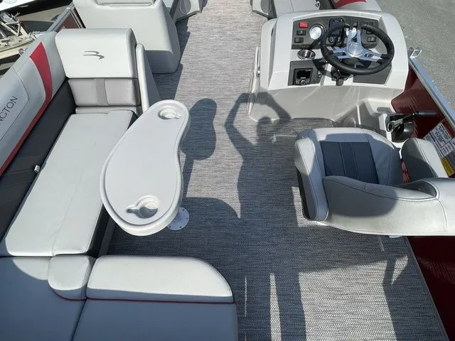 Slide: The Image of 2023 Bennington 20 SXL pontoon boat interior with seating, table, and helm. - 4