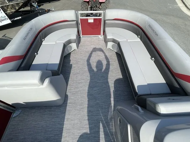 Slide: The Image of 2023 Bennington 20 SXL pontoon boat interior with gray seating and red accents. - 5
