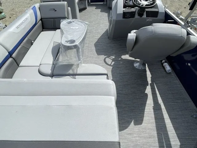 Slide: The Image of 2023 Bennington 20 SXL pontoon boat interior with gray seating and steering console. - 3