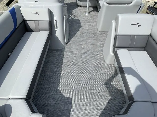 Slide: The Image of 2023 Bennington 20 SXL boat interior with gray seating and carpet flooring. - 8