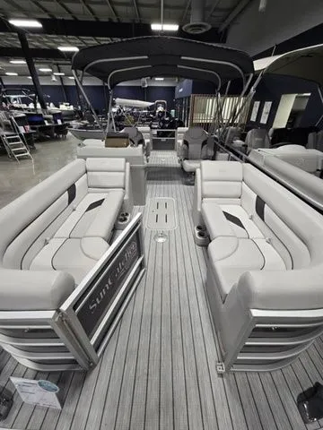 Slide: The Image of 2024 SunCatcher Select 322RC pontoon boat with spacious seating and modern design in showroom. - 4