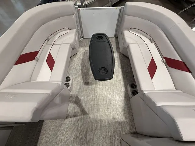 Slide: The Image of 2023 SunCatcher Select 20RC boat interior with beige seating and red accents. - 11