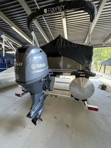 Slide: The Image of 2024 Godfrey Pontoons Mighty G 1476 F with Yamaha outboard motor in covered dock. - 10