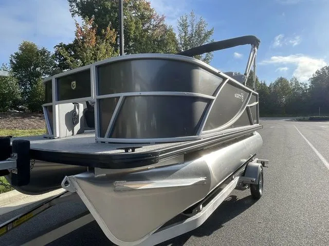 Slide: The Image of 2024 Godfrey Pontoons Mighty G 1476 F pontoon boat on trailer, parked outdoors. - 9