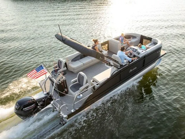 The Image of 2025 Barletta Boats A22CC cruising on a lake with passengers enjoying the ride. - 1
