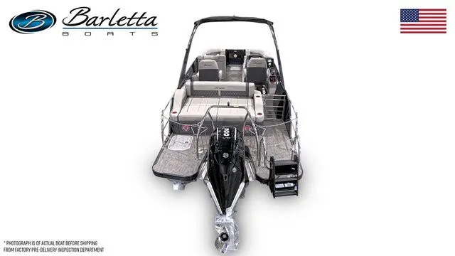 Slide: The Image of 2025 Barletta Boats L23UCA pontoon boat, rear view, showcasing seating and motor, with American flag. - 6